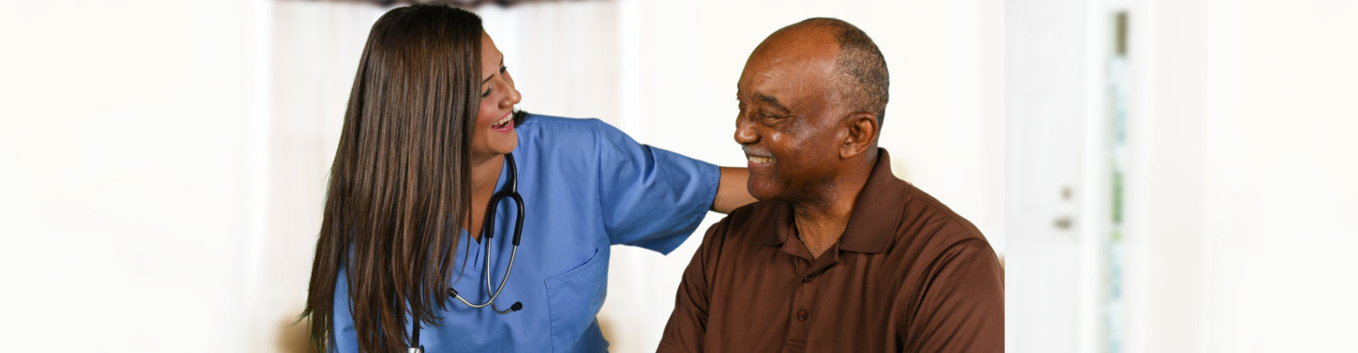 senior man and female nurse smiling